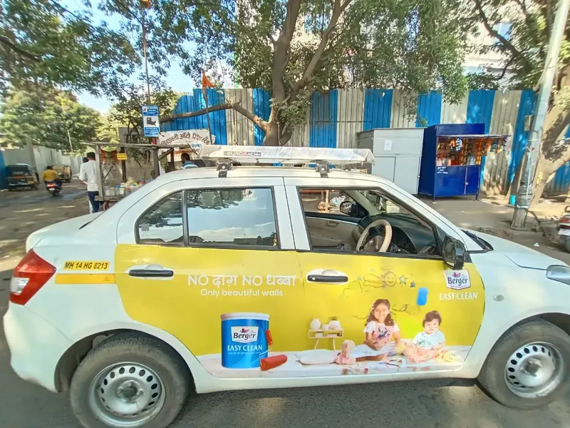 Berger Paints branded cab on a city road in Pune
