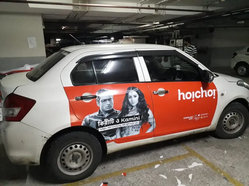 Hoichoi car wrap on a white sedan in Kolkata