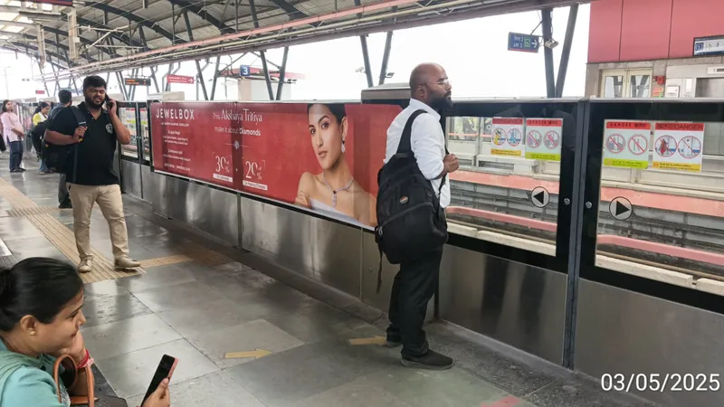 Commuters beside Jewelbox platform panels, Mayur Vihar Phase-I